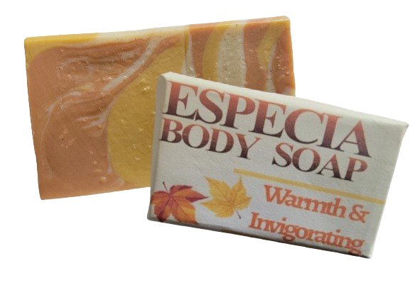 A bar of Especia Body Soap with a swirl of autumn-inspired colors, accompanied by its packaging which reads 'Especia Body Soap' and 'Autumn Swirl'. The packaging also has a leaf design, indicating a seasonal theme.