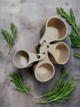 Load image into Gallery viewer, A set of natural wood measuring cups 
